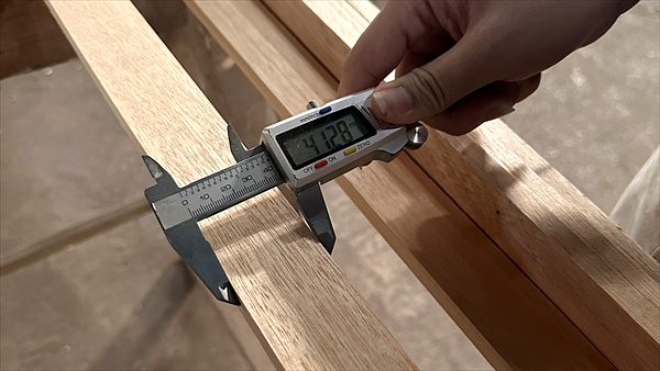 Digital caliper checking the finished thickness of a machined section