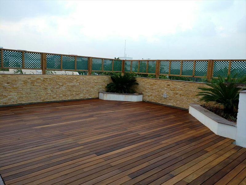 Completed rooftop hardwood deck with planters