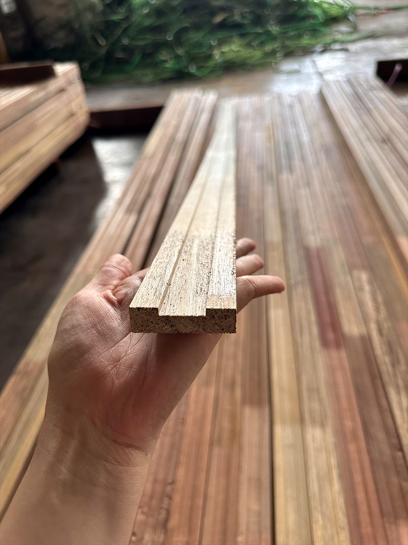 Hand holding a machined timber lipping section
